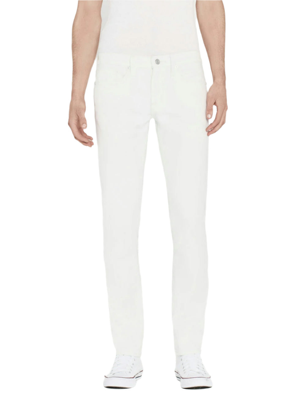 Someone wearing Frame's L'Homme Slim jeans, a white shirt, and white sneakers stands facing forward against a plain background.
