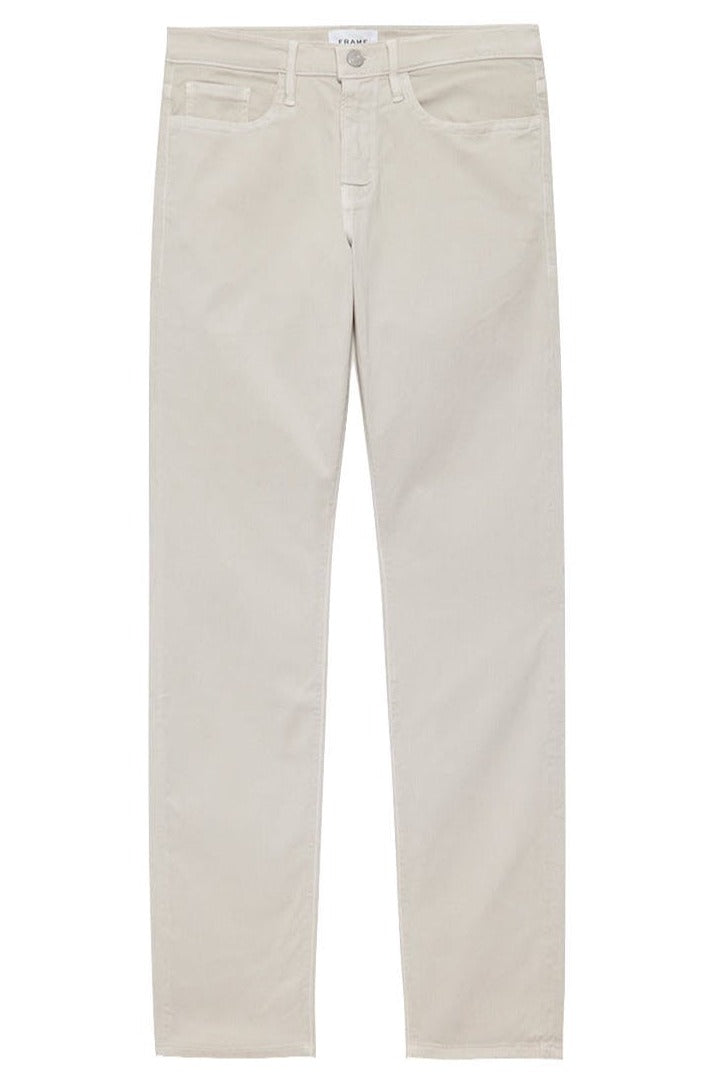 Frame Men's L’Homme Sand Stone Slim Denim by Frame are mid-rise, cream-colored jeans featuring a slim-fit design with a button and zip fly. Made from super stretch denim, they include the standard five-pocket layout.