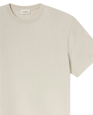 The Logo Tee by Frame is a beige, short-sleeve crewneck made from premium cotton with a round neckline and an inside collar label featuring the brand name.