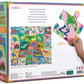 Back of the Eeboo Alphabet of Dinosaurs 36 Piece Giant Puzzle box displays a colorful puzzle image, description, and a hand holding a big "Z" dinosaur piece, all with Sarah Walsh’s vibrant artwork.