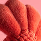 Close-up of the Jellycat Larry Lobster Sailor Outfit, featuring soft, plush red fabric with textured, rounded sections—set against a solid pink background—ready for playful nautical adventures.