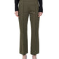 A person is wearing the Lola Pant by Callas Milano—olive green tailored flared trouser pants crafted from stretch crepe knit—paired with a black long-sleeve shirt and black pointed-toe heels, standing against a white background.