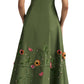A woman in a Lela Rose Seam Detail Scoop Neck Taffeta Midi Dress with floral embroidery stands facing away, wearing white shoes and pearl earrings.