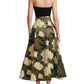 A woman seen from behind wears the Lela Rose Parker Floral Velvet Skirt, a black and olive floral circle skirt with a corseted waist.