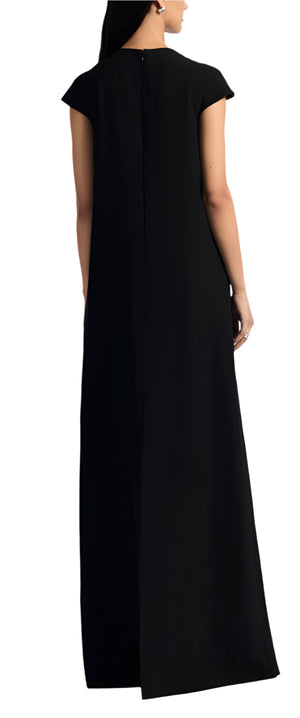 Someone is shown from behind wearing the Lela Rose Augusta Embroidered Gown, a long black dress with floral embroidery and short sleeves. Their arms hang by their sides.