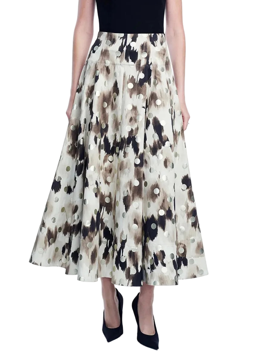 A person wearing a black sleeveless top, the Lela Rose Ikat Polka Parker Skirt—a beige and brown floral patterned high waist skirt—and black heels, shown from the front.