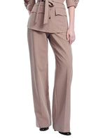 A person is wearing the Lela Rose Melange Crepe High Waisted Pant in taupe, styled with a matching tailored jacket; the pants have a wide-leg silhouette, black shoes are visible, and the background is white.