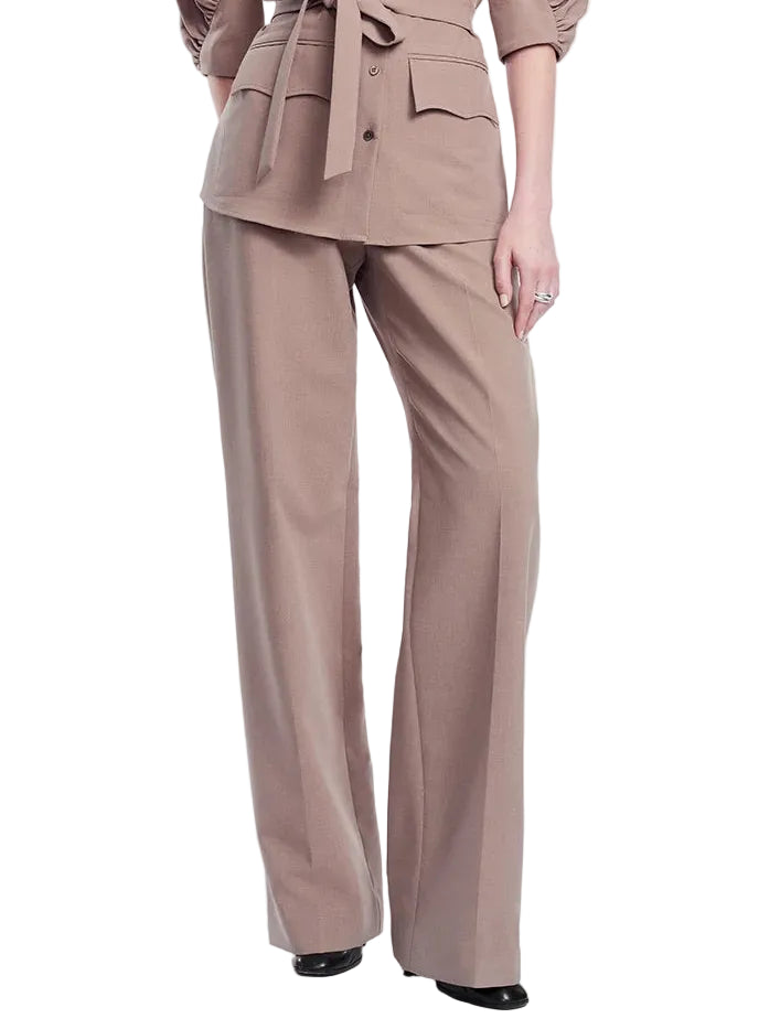 A person is wearing the Lela Rose Melange Crepe High Waisted Pant in taupe, styled with a matching tailored jacket; the pants have a wide-leg silhouette, black shoes are visible, and the background is white.
