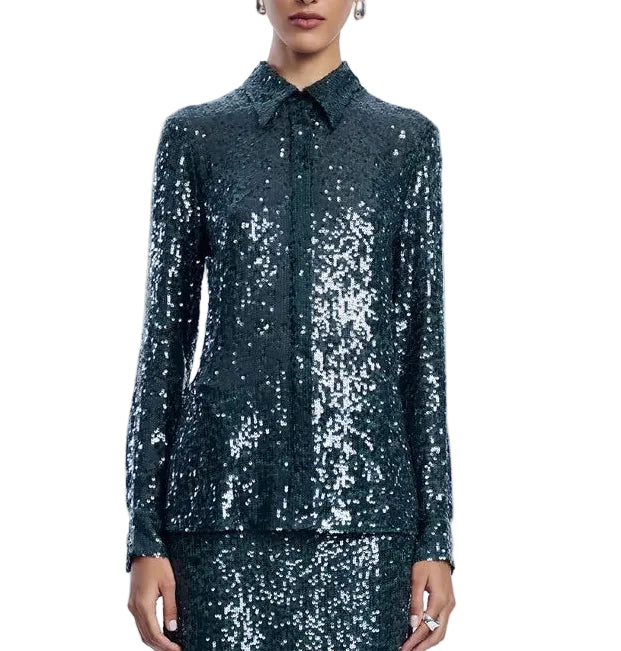 A person wearing the Lela Rose Sequin Lucy Shirt—a dark green, long-sleeved sequin top—paired with a matching skirt, stands against a white background, showcasing a true statement piece that exudes sophistication.
