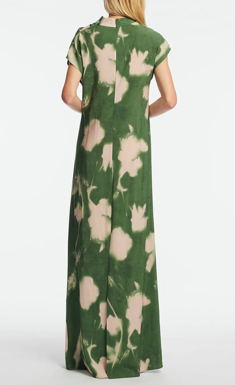 A person wears the Lela Rose Abstract Floral Crepe Draped Gown, featuring a straight-fit silhouette and short sleeves, shown from the back against a plain background.