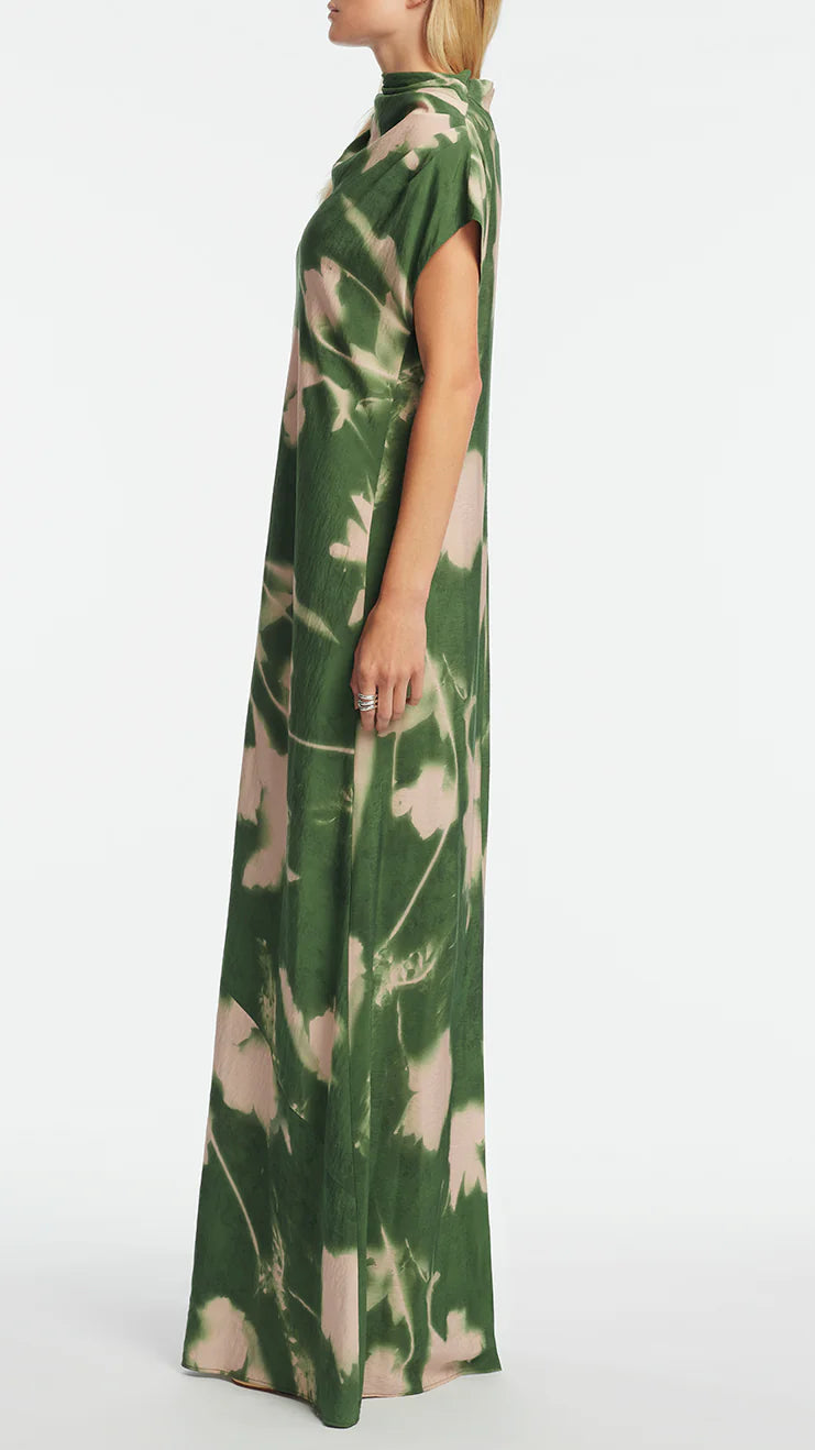 A person wearing the Lela Rose Abstract Floral Crepe Draped Gown stands in profile against a plain white background.