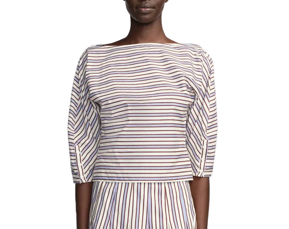 A person wearing the Lela Rose Striped Cotton Dolman Sleeve Top—a boat-neck, navy and red striped piece—paired with a matching vertical-stripe skirt for an effortlessly chic workwear look.