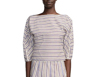A person wearing the Lela Rose Striped Cotton Dolman Sleeve Top—a boat-neck, navy and red striped piece—paired with a matching vertical-stripe skirt for an effortlessly chic workwear look.
