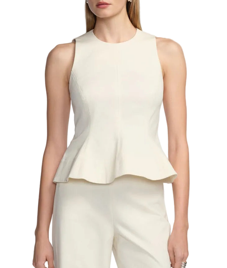 A woman wears the Lela Rose Stretch Cotton Halter Top—a cream, sleeveless, tailored-fit piece with a flared hem—along with matching pants, standing against a plain white background.