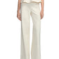 Model in Lela Rose Stretch Cotton Pant, featuring a tailored, high-rise waist in cream, paired with a matching peplum top; photographed from shoulders to feet against a white background.