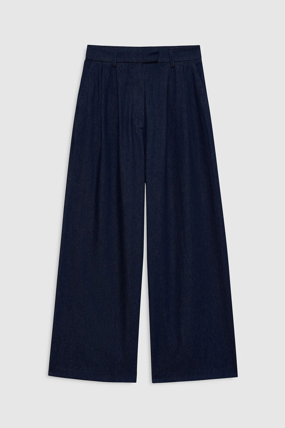 The Lou Trouser by Anine Bing features wide-leg, dark blue cotton denim with a high-rise trouser fit and pleated detailing, shown laid flat on a light gray background—reflecting Anine Bing’s signature style.