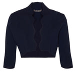 The Lela Rose Scallop Trim Knit Bolero is a dark blue, long-sleeve, cropped jacket made from stretch crepe material and features scalloped edges.