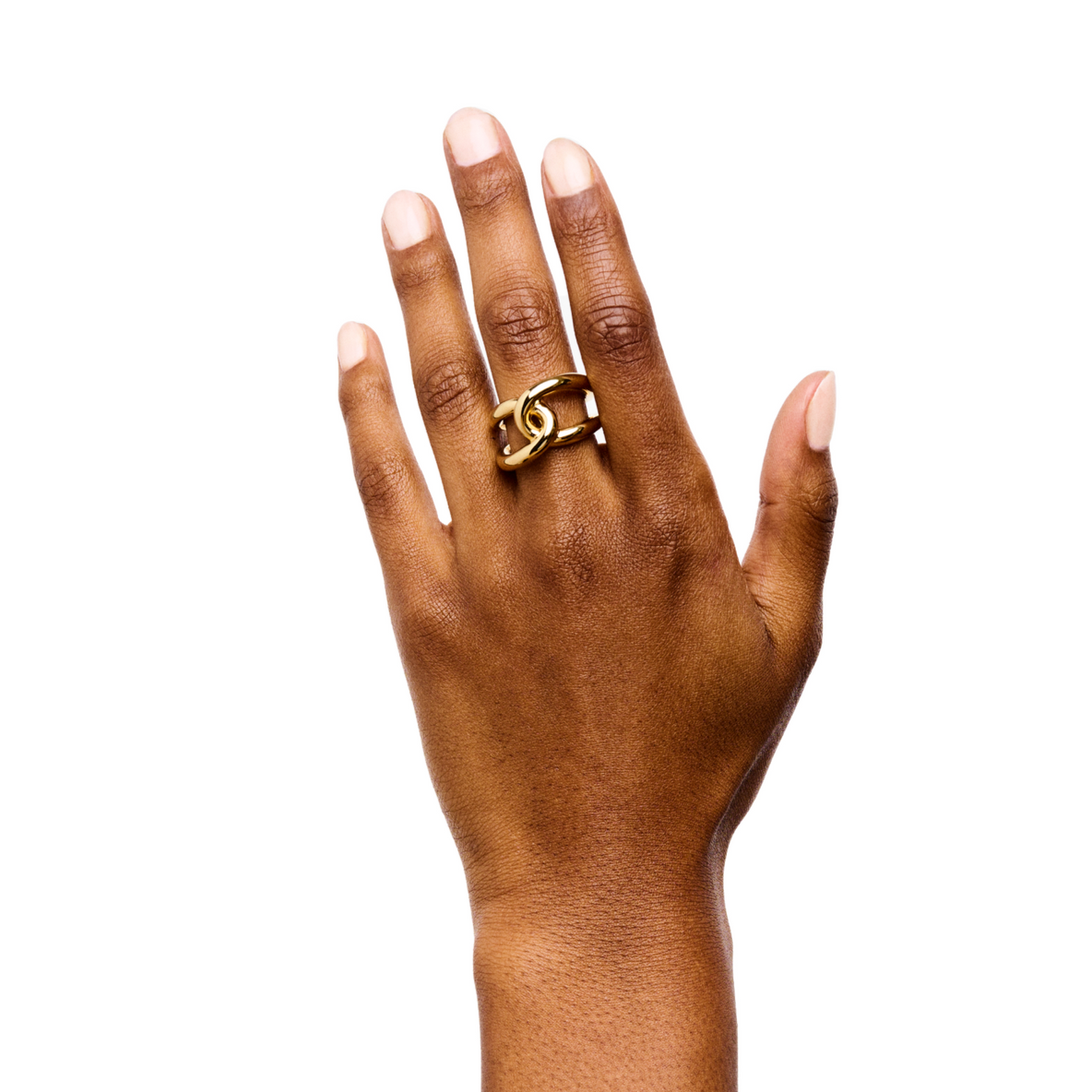 A hand adorned with the Lie Studio Agnes Ring, meticulously crafted from 18-carat gold vermeil and featuring a detailed interlocking chain design, is showcased against a white background.