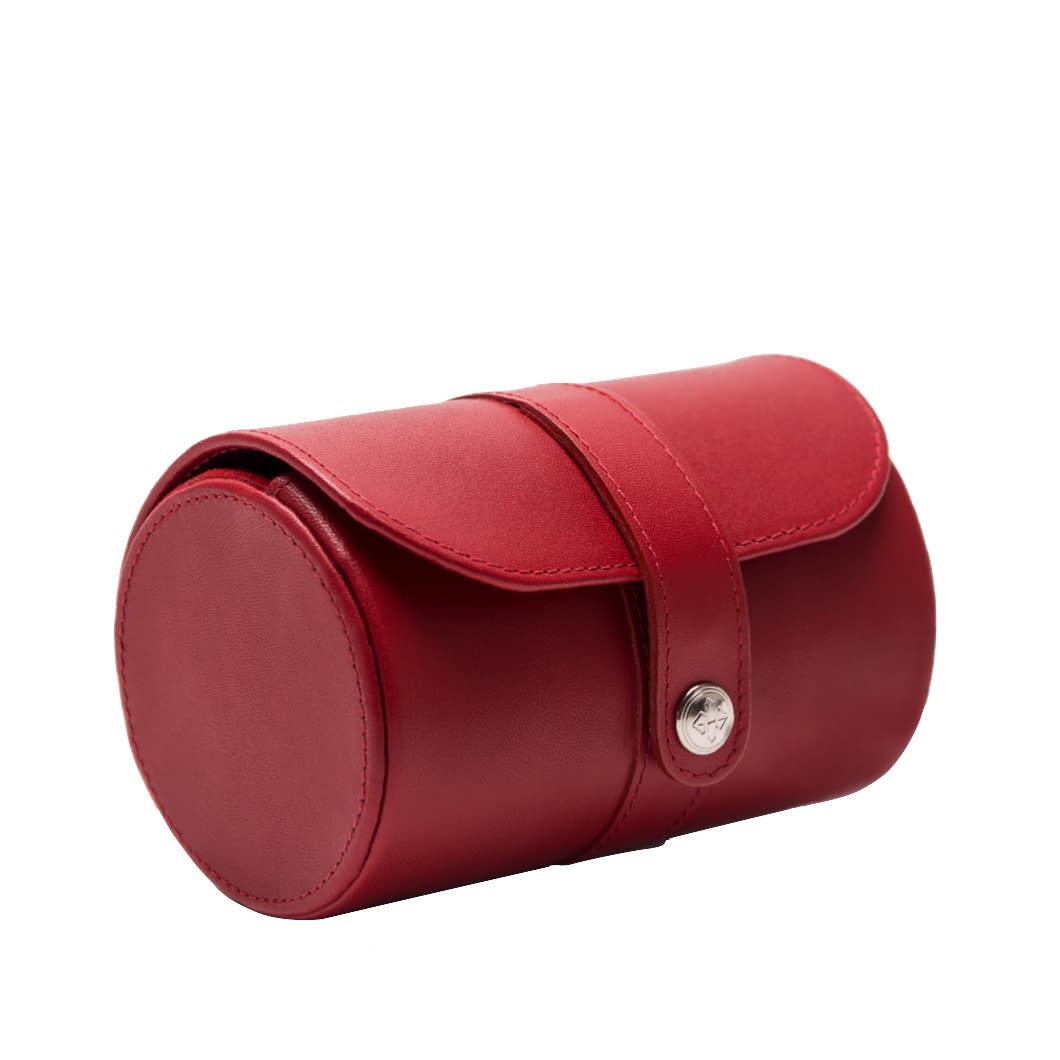 The Ettinger Lifestyle Leather Double Watch Roll is a compact, cylindrical red leather travel watch case with a snap button closure on the side.