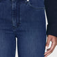 Someone wearing Frame's Le Sleek Straight high-rise dark blue jeans and a black sweater, with their right hand by their side.