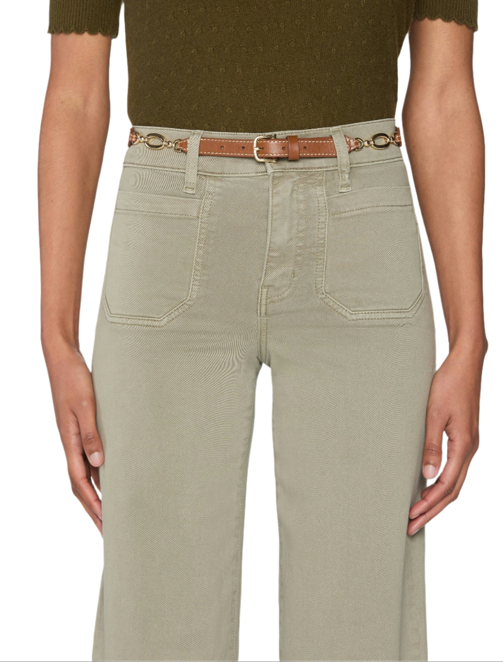 A person wears Frame’s Le Slim Palazzo Modernist Pocket light khaki high-rise pants with front pockets, paired with a brown belt and a dark green short-sleeve top.