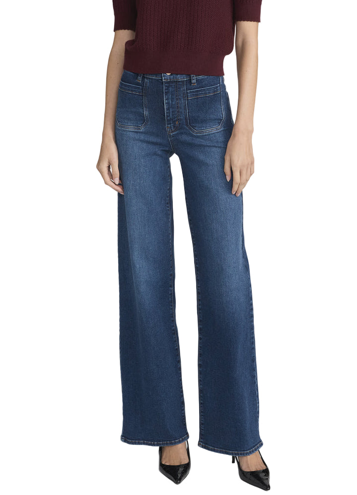 A person wearing a burgundy short-sleeve top, Frame's Le Slim Palazzo Modernist Pocket high-rise palazzo pants in blue, and black pointed-toe heels.