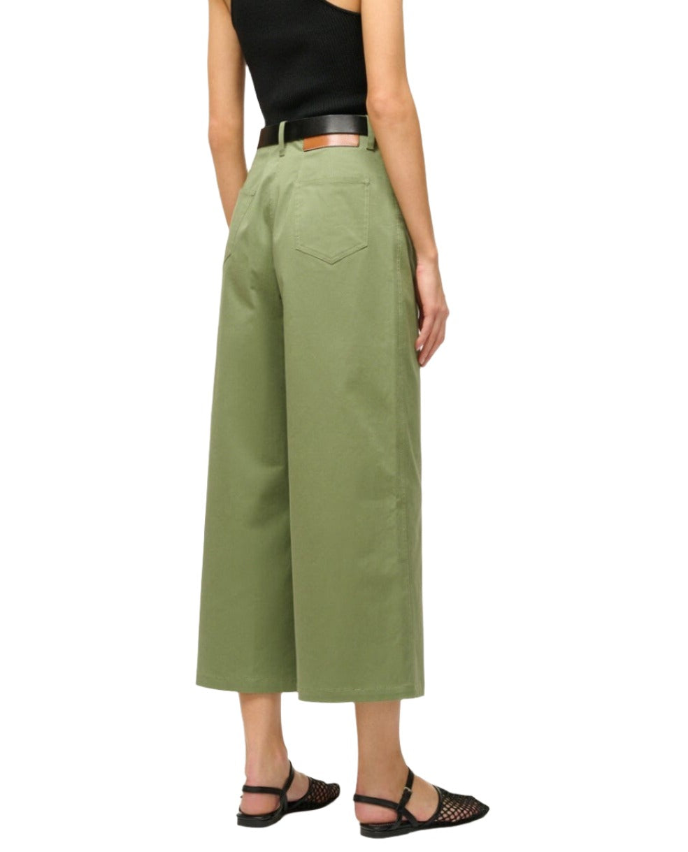 Person wearing Staud Luca Pant in olive green, a black tank top, and black sandals, shown from the back.