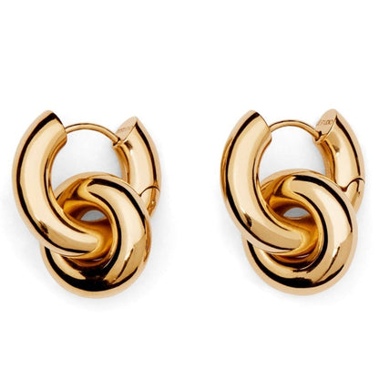 The LIÉ STUDIO Esther Earrings by Lie Studio are a pair of gold-plated brass hoop earrings featuring intertwined loops that create a knot-like design, making them perfect statement earrings.