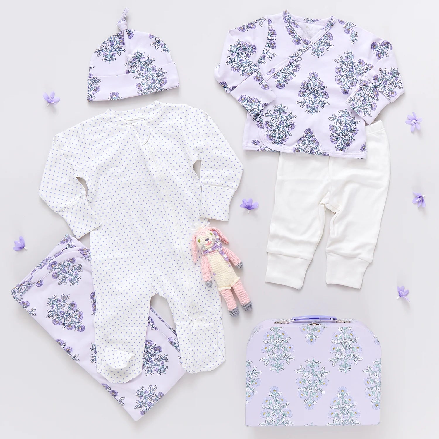 Beautifully arranged, the Pink Chicken Nesting Box Baby Take Home Set includes a hat, patterned shirt, white pants, polka-dot onesie, floral blanket, doll, and suitcase—making it the perfect newborn gift set.