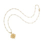 The Jane Win Letter Pendant Satellite Necklace Collection features a gold beaded chain with a 14k gold personalized letter "J" pendant and star detail, shown on a white background.