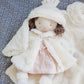 The Bunnies By the Bay Glad Dreams Elsie Doll, with brown hair, a pink dress, striped stockings, and matching white blanket, is a delightful addition to any keepsake wardrobe box.