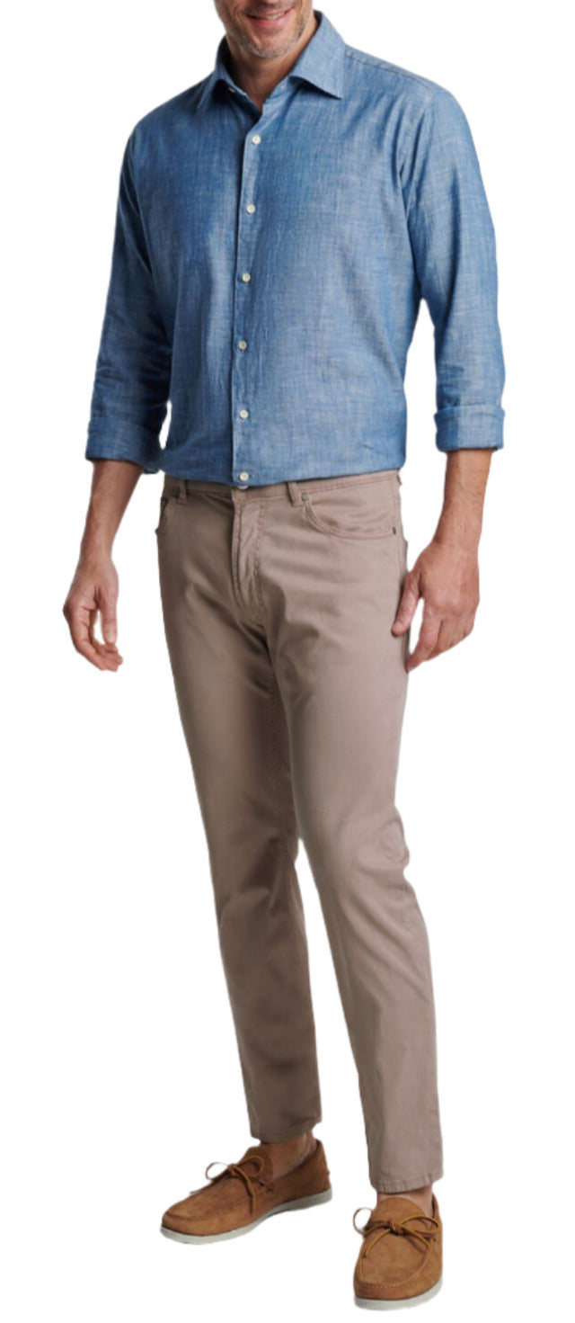 A man wearing a Peter Millar Japanese Selvedge Sport Shirt, khaki pants, and brown loafers stands facing forward.