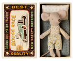 A small Maileg Little Brother mouse wearing pajamas rests in a matchbox bed adorned with a vintage racecar design and text that reads: "Grand Old Match Factory, Best Quality, Mouse Race, New Safety Matches.