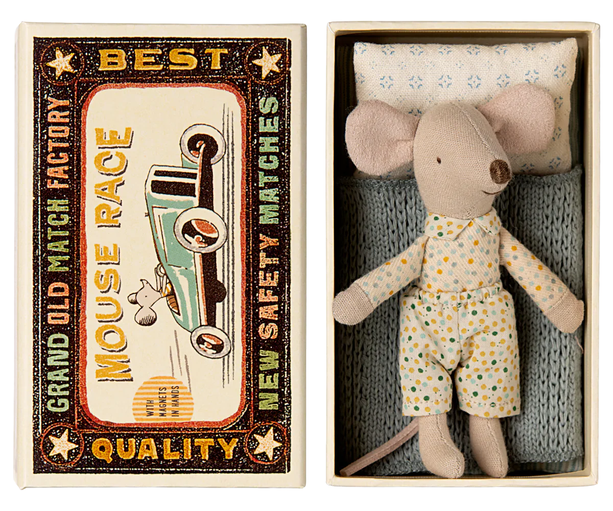 A small Maileg Little Brother mouse wearing pajamas rests in a matchbox bed adorned with a vintage racecar design and text that reads: "Grand Old Match Factory, Best Quality, Mouse Race, New Safety Matches.