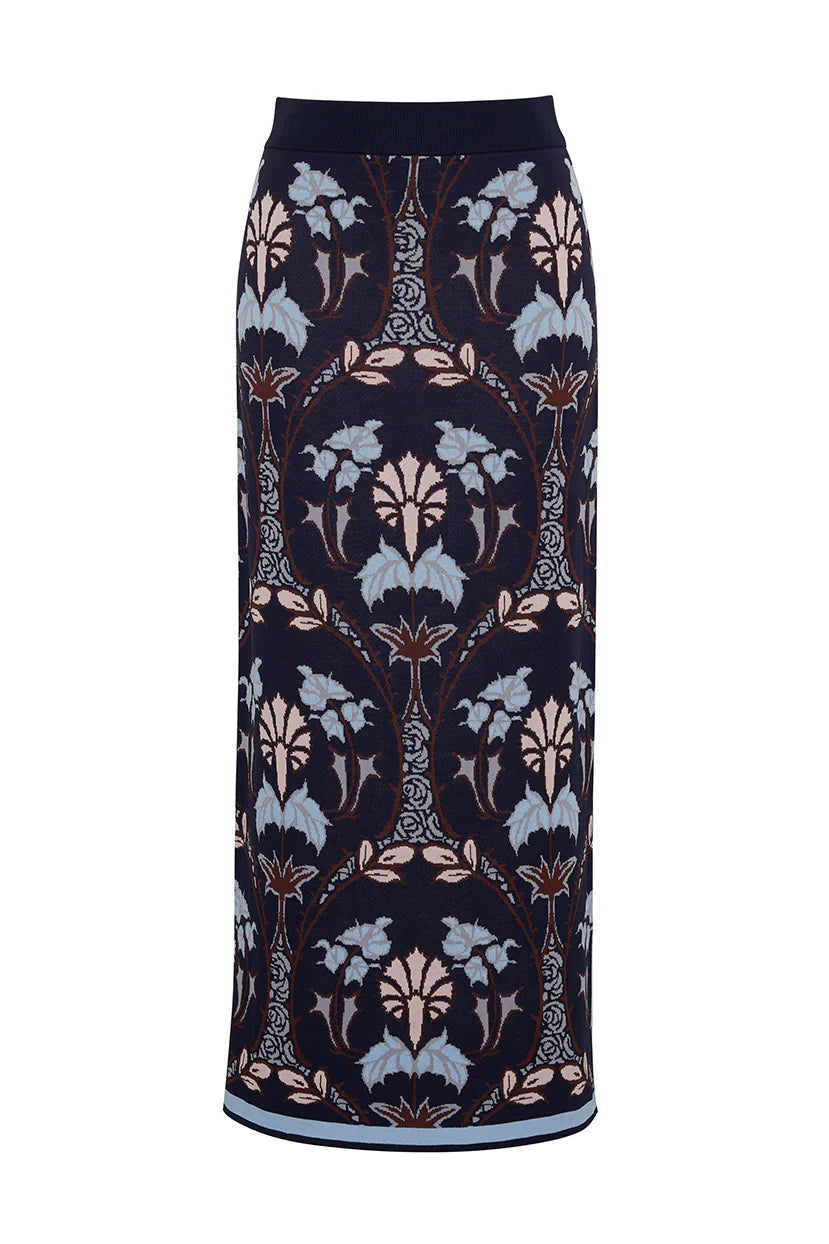 The Cara Cara Lillian Skirt from Cara Cara features a jacquard knit in navy blue, beige, and light blue floral patterns within vertical symmetrical ovals, offering the elegance of a pencil shape.