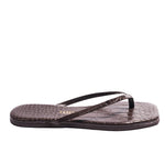 The Tkees Lily Square Toe Croc Sandal is shown in side profile, featuring brown crocodile-embossed leather with thin straps and a square toe.