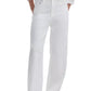 Person wears Rag & Bone Featherweight Logan Wide jeans in white, paired with a white long-sleeve shirt and white pointed-toe shoes, standing with hands in pockets.
