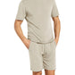 A person wearing a matching Eberjey Henry Short PJ Set made from temperature-regulating TENCEL™ Modal stands with hands in pockets against a white background.