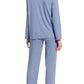 Rear view of a woman wearing a light blue striped *Eberjey Gisele Rib Long PJ Set* pajama set, standing barefoot.