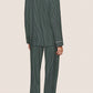 A person stands barefoot facing away against a plain light background, wearing the Eberjey Gisele Printed Stripe Long PJ Set in dark green pinstripes.