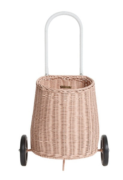 A wheeled pink Luggy Basket on a white background for kids by Olli Ella.