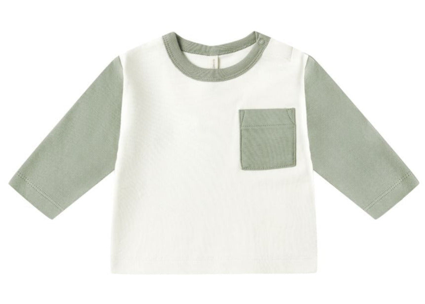 The Quincy Mae Baby Boys' Long Sleeve Raglan Tee features sage green sleeves, a white body, matching sage collar, and a left chest pocket in organic brushed cotton for a relaxed fit.
