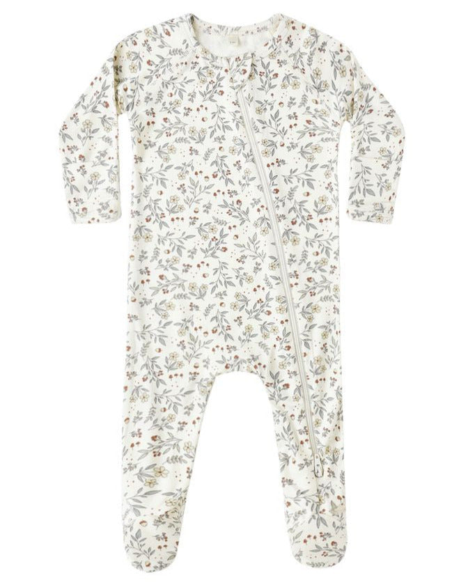 The Quincy Mae Baby Bamboo Zip Footie features a small floral print, long sleeves, covered feet, and a diagonal front zipper for cozy comfort.
