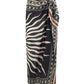 The Golden Horizon Pareo by Johanna Ortiz features a black and beige geometric and zebra stripe pattern in a wrap style with a side knot—ideal for styling as a skirt or versatile scarf.
