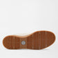 The Peter Millar Drift Mesh Sneaker features a brown rubber sole with a textured herringbone traction pattern and a circular logo at the center, shown against a white background.