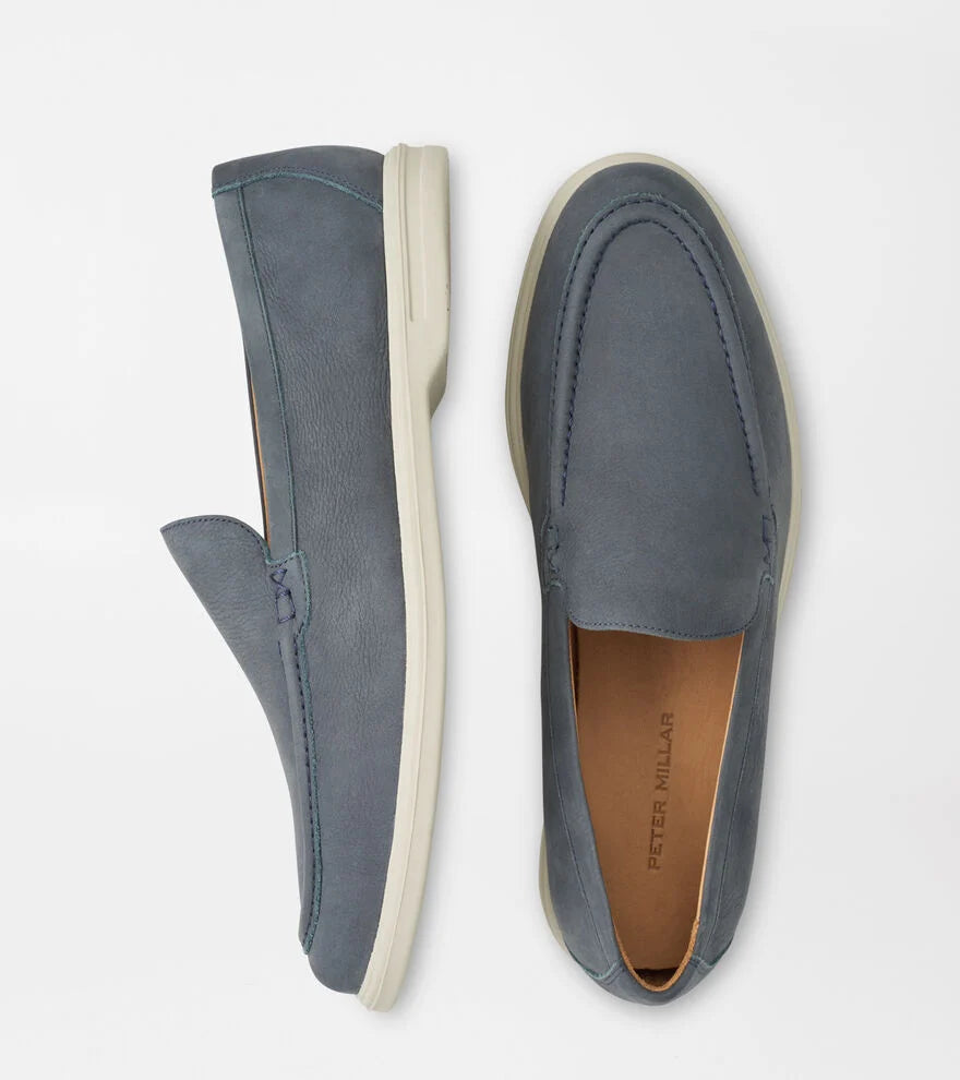 The Peter Millar Excursionist Nubuck Venetian Loafer, a blue lightweight shoe with white soles, is displayed from side and top view on a plain white background.