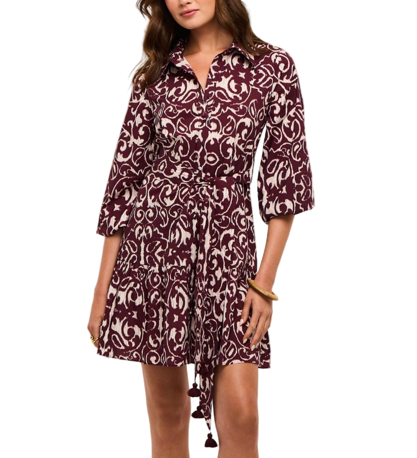 A woman wears the Figue Marcy Dress, a maroon and white patterned shirt dress with a collar, three-quarter sleeves, and a tie belt at the waist.