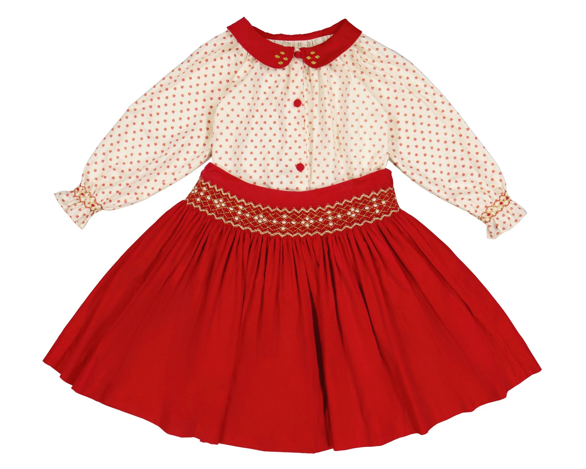 The Antoinette Girls' Marie Red Floral Smocked Skirt and Blouse Set features a cream long-sleeved handmade blouse with a red collar, red buttons, and a bright red corduroy skirt with floral embroidery at the waist.