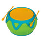 A round, green and blue Crocodile Creek Super Drum with a yellow top and two yellow drumsticks resting on its edge makes the perfect kids’ drum musical instrument.