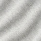 Close-up of the Crown Comfort Pullover by Peter Millar, showcasing its light grey, textured fabric with a subtle diagonal ribbed pattern. The material is soft and slightly heathered, delivering sweatshirt-like comfort—ideal for a lightweight layer or quarter-zip pullover.